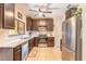 Kitchen with stainless steel appliances, dark cabinets, and light countertops at 6078 Tivoli Gardens Blvd, Orlando, FL 32829