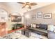 Cozy living room with a flat-screen television, comfortable seating, and archway to the next room at 6078 Tivoli Gardens Blvd, Orlando, FL 32829