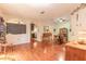 Open-concept living room with hardwood floors and archways to the kitchen and dining area at 6078 Tivoli Gardens Blvd, Orlando, FL 32829