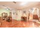 Spacious living room with hardwood floors, dining set, and staircase to the upper level at 6078 Tivoli Gardens Blvd, Orlando, FL 32829