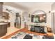 Open-concept living room featuring a large flat screen television, wood flooring, and stainless steel appliances at 6078 Tivoli Gardens Blvd, Orlando, FL 32829