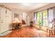 Living room with hardwood floors, a staircase, and a large window with natural light at 6078 Tivoli Gardens Blvd, Orlando, FL 32829