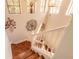 View of the stairway going up with railing, wood stairs, and a number of windows above at 6078 Tivoli Gardens Blvd, Orlando, FL 32829