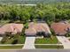 Expansive aerial shot of a neighborhood showcasing tile roofs and lush landscaping at 6111 Oxbow Bend Ln, Port Orange, FL 32128