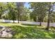 Large grassy backyard, enclosed by a white fence and lined with mature trees, offers privacy and space at 6111 Oxbow Bend Ln, Port Orange, FL 32128