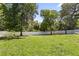Expansive backyard with mature trees and a white picket fence, offering privacy and space at 6111 Oxbow Bend Ln, Port Orange, FL 32128