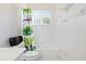 Bright bathroom featuring white wallpaper and fixtures, complete with a whimsical monkey-themed shower curtain at 6111 Oxbow Bend Ln, Port Orange, FL 32128