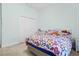 Bedroom featuring a colorful bed, white desk and white closet doors at 6111 Oxbow Bend Ln, Port Orange, FL 32128