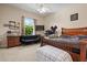 Bedroom with ceiling fan, dark wood furniture, aquarium, and window with view at 6111 Oxbow Bend Ln, Port Orange, FL 32128
