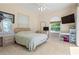 Bright bedroom featuring neutral walls and carpet, complemented by white furniture and a large window at 6111 Oxbow Bend Ln, Port Orange, FL 32128