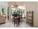 Breakfast nook with a chandelier, table, and backyard view through the screened in lanai at 6111 Oxbow Bend Ln, Port Orange, FL 32128