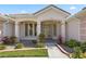 Elegant front entrance with beautiful glass doors, manicured landscaping, and a tiled walkway at 6111 Oxbow Bend Ln, Port Orange, FL 32128