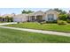 Inviting single-story home showcasing a lush green lawn, two-car garage, and pleasing architectural details at 6111 Oxbow Bend Ln, Port Orange, FL 32128