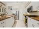 Bright kitchen features stainless steel appliances, granite countertops, and white cabinetry at 6111 Oxbow Bend Ln, Port Orange, FL 32128
