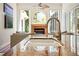 Granite kitchen island with sink offers a view of the living room and fireplace at 6111 Oxbow Bend Ln, Port Orange, FL 32128