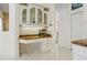 Kitchen workstation boasts white cabinetry, granite counters, display cabinet, and tile flooring at 6111 Oxbow Bend Ln, Port Orange, FL 32128