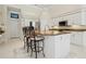 Bright kitchen with white cabinetry, granite countertops, stainless steel appliances, and breakfast bar at 6111 Oxbow Bend Ln, Port Orange, FL 32128