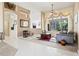 Modern living room with stylish furniture, tile flooring, and a large window with backyard views at 6111 Oxbow Bend Ln, Port Orange, FL 32128