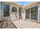 Cozy outdoor patio area featuring a patterned tile floor and views of the lush backyard landscape at 6111 Oxbow Bend Ln, Port Orange, FL 32128