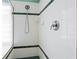 Shower features white tiled walls with dark green accents at 6111 Oxbow Bend Ln, Port Orange, FL 32128