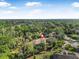 Expansive aerial view of estate, lush landscaping, and secluded pool offer a private retreat at 6247 Palomino Cir, Port Orange, FL 32127