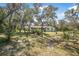 Spacious backyard featuring mature trees providing ample shade and privacy at 6247 Palomino Cir, Port Orange, FL 32127