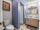 Bathroom features a vanity with a gold-trimmed mirror, and a shower with a white curtain at 6247 Palomino Cir, Port Orange, FL 32127