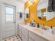 Bright bathroom with double sink vanity, white door and neutral hexagon tile floor at 6247 Palomino Cir, Port Orange, FL 32127