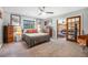 Bedroom featuring warm decor, ceiling fan, gray walls, and wood sliding doors to another room at 6247 Palomino Cir, Port Orange, FL 32127