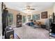 Bedroom with carpet, ceiling fan, multiple windows, and a desk in a naturally lit room at 6247 Palomino Cir, Port Orange, FL 32127
