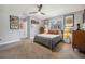 Spacious bedroom with modern ceiling fan, gray walls, carpet flooring, and decor at 6247 Palomino Cir, Port Orange, FL 32127