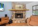 Close-up of a stone fireplace with a wooden mantel, creating a cozy and inviting atmosphere at 6247 Palomino Cir, Port Orange, FL 32127
