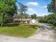 Beautiful single-story home featuring manicured lawn and extended driveway at 6247 Palomino Cir, Port Orange, FL 32127