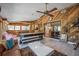 This game room features a billiards table, wood paneled walls, and an adjacent sun room for relaxation at 6247 Palomino Cir, Port Orange, FL 32127