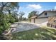 Long driveway leading to attached garage and stonework on home's facade at 6247 Palomino Cir, Port Orange, FL 32127