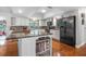 A well-lit kitchen with a granite countertop island and modern appliances, showcasing ample counter space at 6247 Palomino Cir, Port Orange, FL 32127