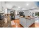 The kitchen features sleek granite countertops, stainless steel appliances, and wood flooring for a modern aesthetic at 6247 Palomino Cir, Port Orange, FL 32127