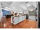 Open concept kitchen featuring a center island with seating, stainless steel appliances, and hardwood flooring at 6247 Palomino Cir, Port Orange, FL 32127