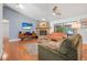 Cozy living room featuring a stone fireplace, hardwood floors, and lots of natural light at 6247 Palomino Cir, Port Orange, FL 32127