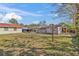 Backyard area showing the covered carport and shed, with other houses nearby at 630 Florida Ave, Daytona Beach, FL 32117