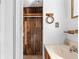 Bathroom area featuring wood paneling in the closet, towel rack, and mirrored medicine cabinet at 630 Florida Ave, Daytona Beach, FL 32117