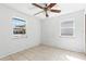 Cozy bedroom with tile floors, two windows, and a ceiling fan at 630 Florida Ave, Daytona Beach, FL 32117