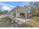 Wide view of the house's covered carport, the home's main structure, and the home's backyard at 630 Florida Ave, Daytona Beach, FL 32117