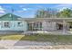 An exterior full view of the home including the front yard and covered carport at 630 Florida Ave, Daytona Beach, FL 32117