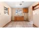 Functional kitchen featuring wood cabinets, a sink under a window, and tile flooring at 630 Florida Ave, Daytona Beach, FL 32117