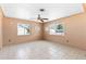 Bright living room featuring tile flooring, a ceiling fan, and many windows at 630 Florida Ave, Daytona Beach, FL 32117