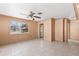 Neutral living room featuring tile flooring, a ceiling fan, and large windows at 630 Florida Ave, Daytona Beach, FL 32117