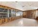 Inviting living room with classic wood paneling and ample natural light from multiple windows at 630 Florida Ave, Daytona Beach, FL 32117