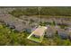 Aerial view of backyard and neighborhood with pond and lush landscaping at 7068 Lanier Falls Rd, Deland, FL 32724
