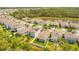 Aerial view of a well maintained neighborhood with a pond and lush landscaping at 7068 Lanier Falls Rd, Deland, FL 32724